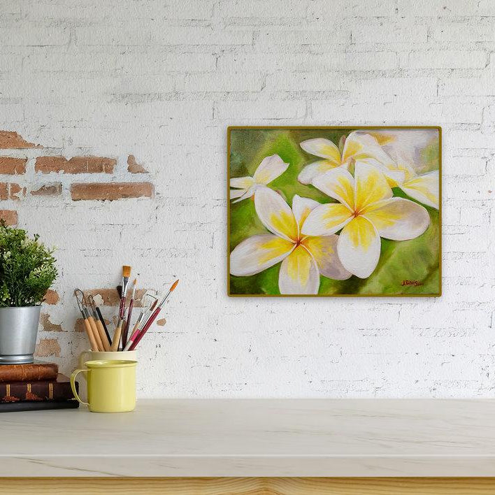 "Plumeria Morning" original painting by Julie Davis displayed on contemporay counter top