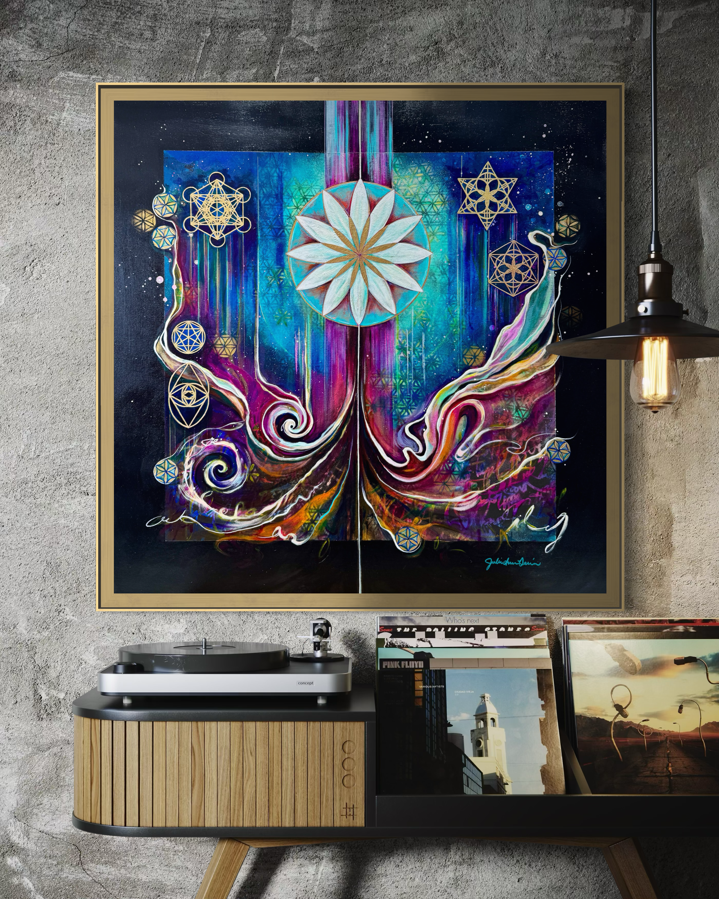 Colorful abstract artwork with floral elements in a gold frame, displayed on a wall above a record player. "Culminating Consciousness" Sacred Geometry Art by Julie Davis.