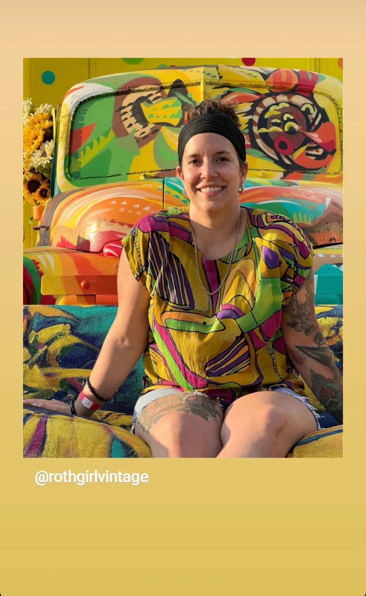 Fair-goer snaps a selfie on the Sunflower Sofa, painted by Julie Davis in front of the Big Art Mural on a school bus by Koda of Witsken of Hue Murals, at the 2022 Indiana State Fair